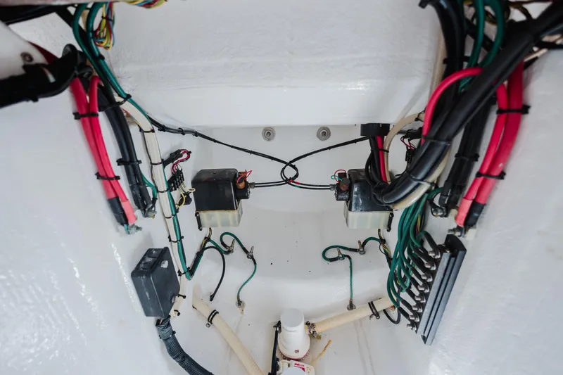 Slide: The Image of Electrical wiring inside a 2014 Intrepid 400 Cuddy boat, showcasing organized cables and components. - 35