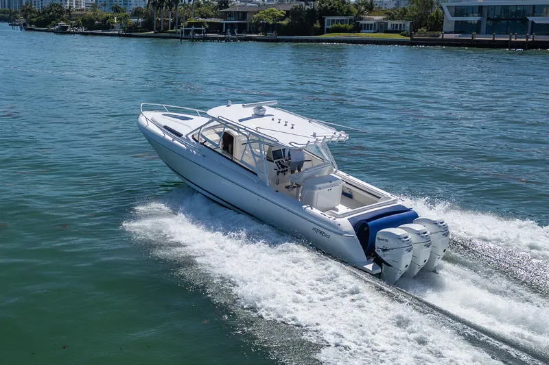 Slide: The Image of 2014 Intrepid 400 Cuddy cruising on a sunny day with triple outboard engines. - 4