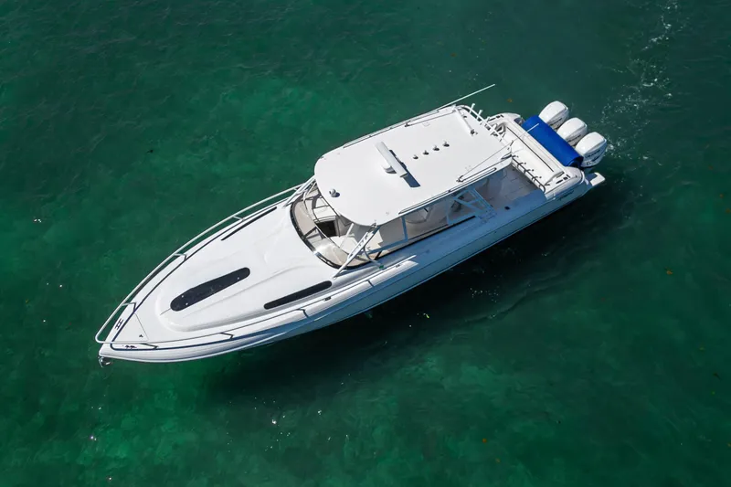 Slide: The Image of 2014 Intrepid 400 Cuddy boat on clear turquoise water, aerial view. - 7