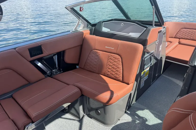 Slide: The Image of 2021 MasterCraft X24 boat interior with brown leather seating and modern design. - 12