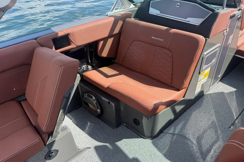 Slide: The Image of 2021 MasterCraft X24 boat interior with brown leather seating and modern design. - 16