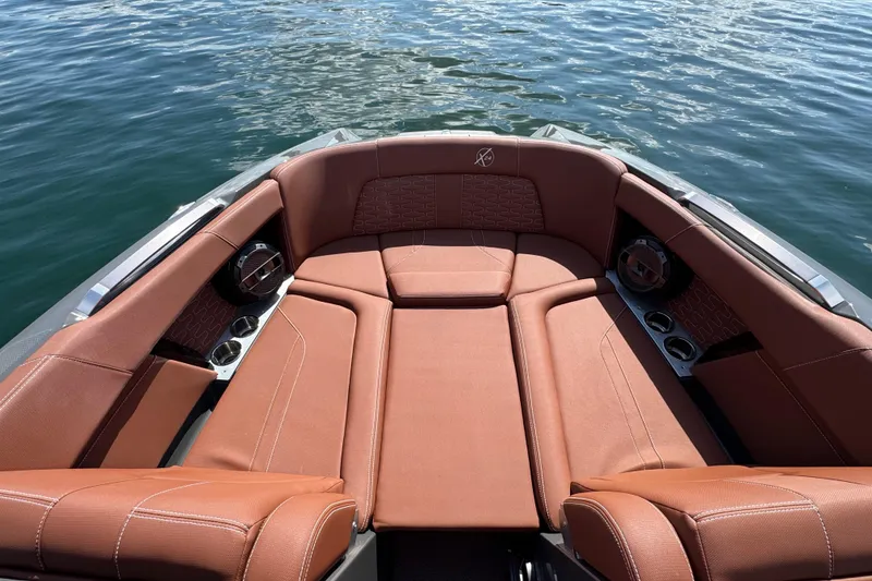 Slide: The Image of Luxurious seating on 2021 MasterCraft X24 boat with brown upholstery and cup holders. - 18