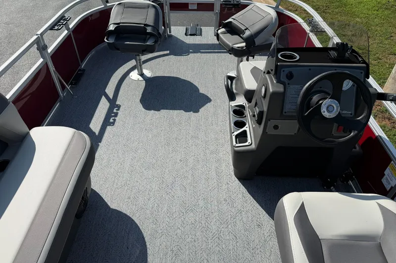 Slide: The Image of 2026 Sun Tracker Bass Buggy 16 XL Select interior with seating and steering console. - 4