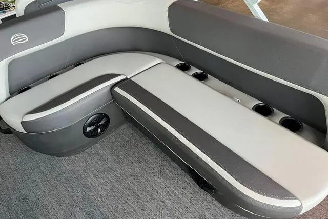 Slide: The Image of Interior seating of 2026 Sun Tracker Bass Buggy 18 DLX with cup holders and speaker. - 2