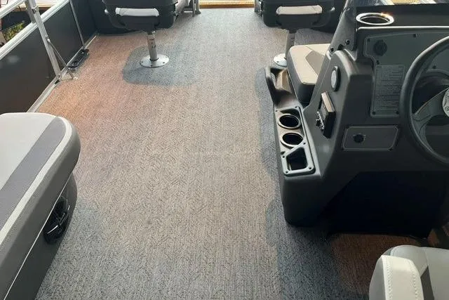 Slide: The Image of Interior of 2026 Sun Tracker Bass Buggy 18 DLX pontoon boat with seating and console. - 3