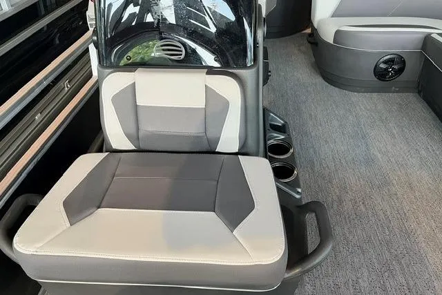 Slide: The Image of Interior of 2026 Sun Tracker Bass Buggy 18 DLX with cushioned seating and cup holders. - 4