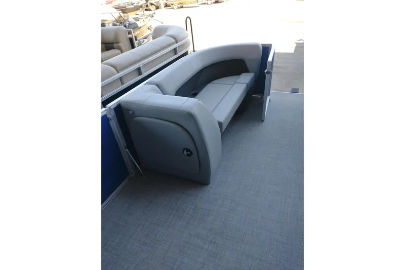 Slide: The Image of 2026 Sun Tracker Party Barge 18 DLX interior with gray seating and spacious deck. - 10