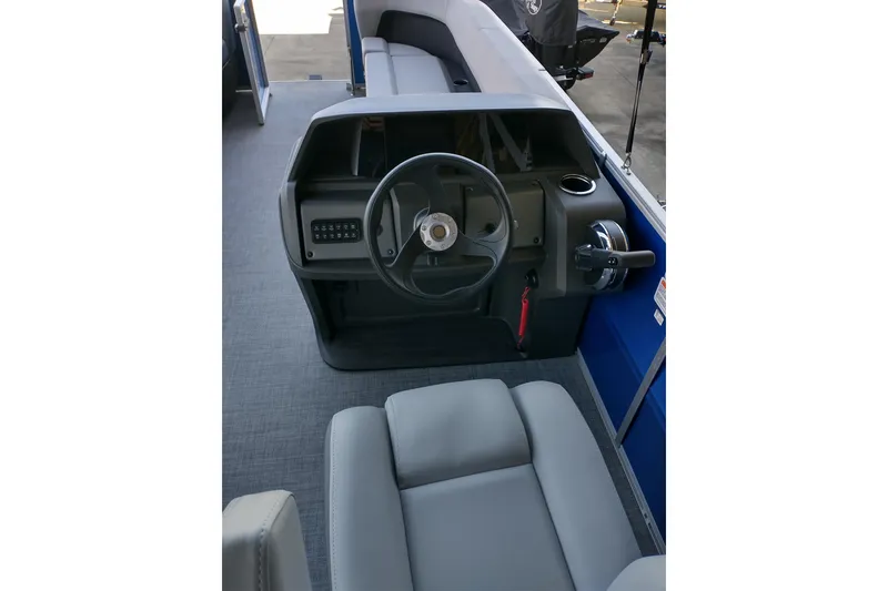 Slide: The Image of 2026 Sun Tracker Party Barge 18 DLX interior with steering wheel and seating. - 11