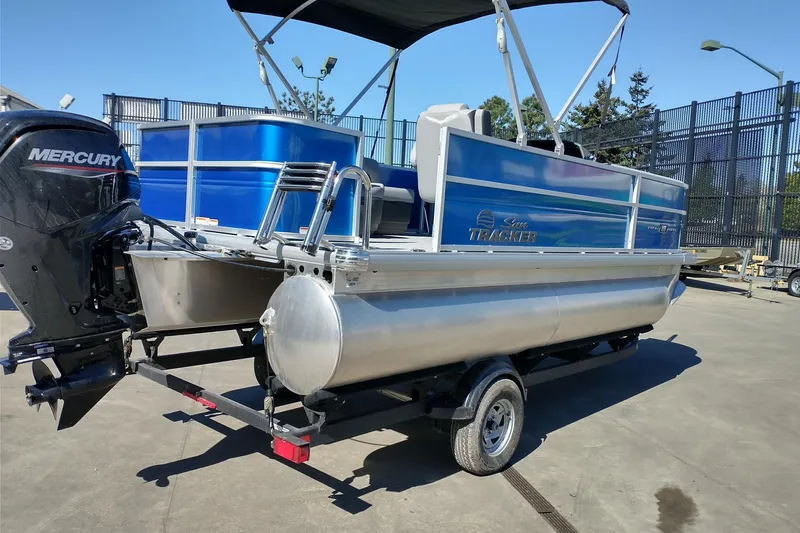 Slide: The Image of 2026 Sun Tracker Party Barge 18 DLX pontoon boat with Mercury engine on trailer. - 3