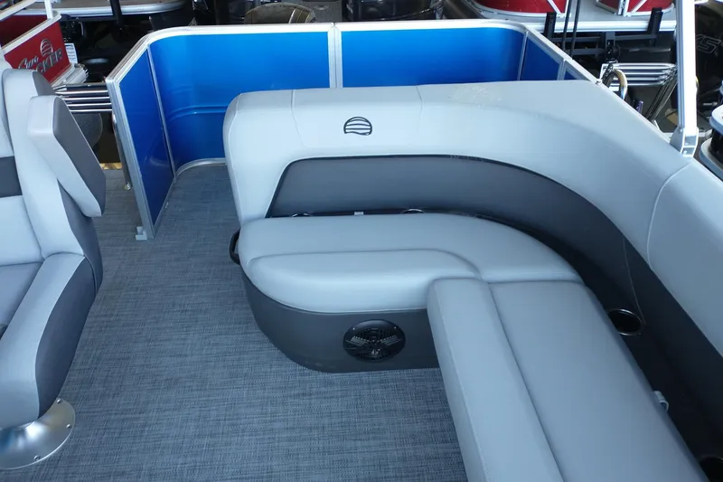 Slide: The Image of 2026 Sun Tracker Party Barge 18 DLX interior with gray seating and blue paneling. - 4