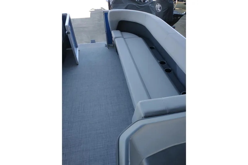 Slide: The Image of 2026 Sun Tracker Party Barge 18 DLX interior with gray seating and cup holders. - 9