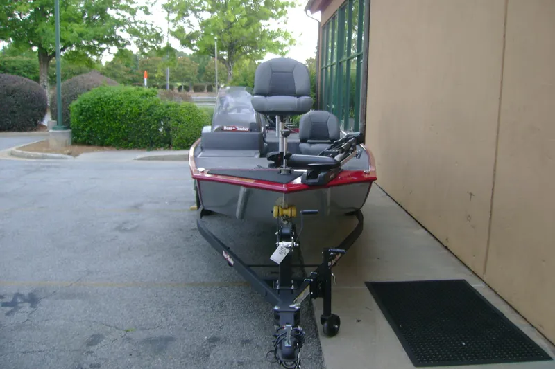 Slide: The Image of 2026 Tracker Bass Tracker Classic XL boat parked outdoors near a building. - 3