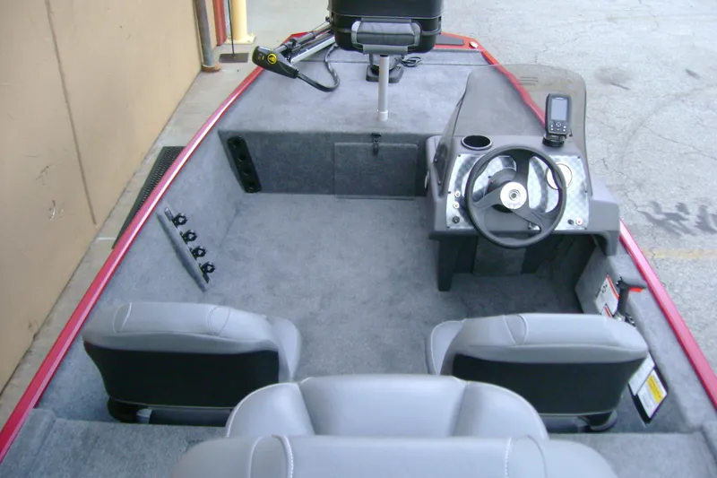 Slide: The Image of 2026 Tracker Bass Tracker Classic XL boat interior with steering wheel and seating. - 6