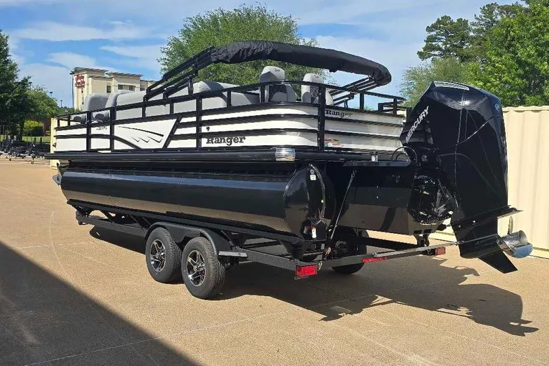 Slide: The Image of 2026 Ranger 223FC pontoon boat with red and black design on trailer. - 3