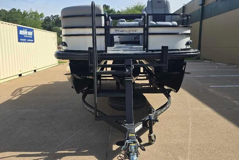 Slide: The Image of 2026 Ranger 223FC boat on trailer in parking lot. - 7