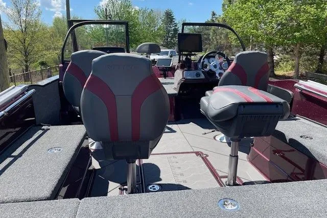 Slide: The Image of 2026 Nitro ZV20 Pro boat interior with modern seating and dashboard, surrounded by lush greenery. - 4