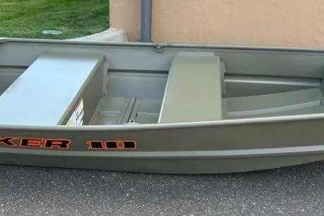 The Image of 2026 Tracker Grizzly 10 Jon boat, olive green, parked on pavement near grass. - 0