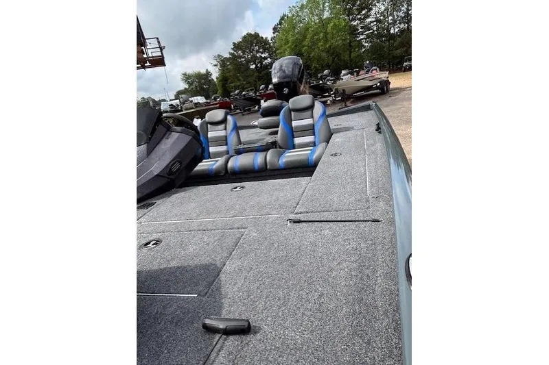 Slide: The Image of 2026 Ranger RT178C fishing boat with gray and blue seating, parked outdoors. - 15