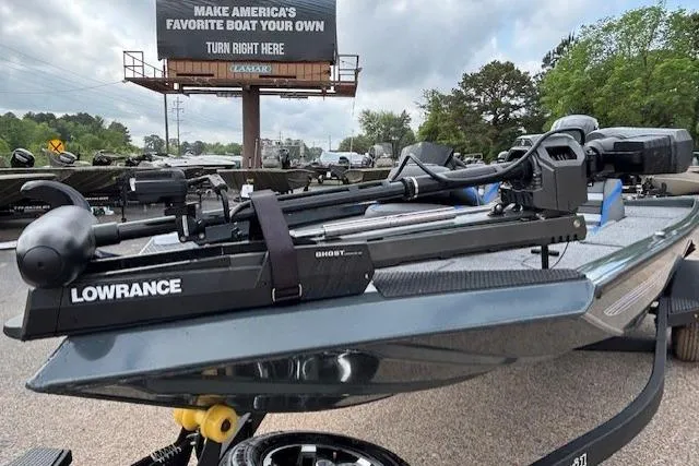 Slide: The Image of 2026 Ranger RT178C boat with Lowrance equipment, parked near a billboard promoting boat customization. - 8