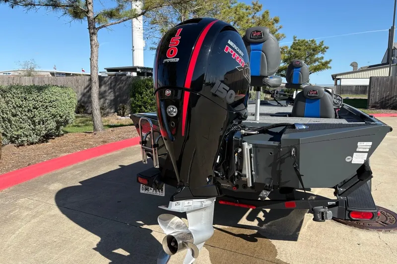 Slide: The Image of 2026 Ranger RT198P boat with Mercury 150 Pro XS engine, parked outdoors. - 17