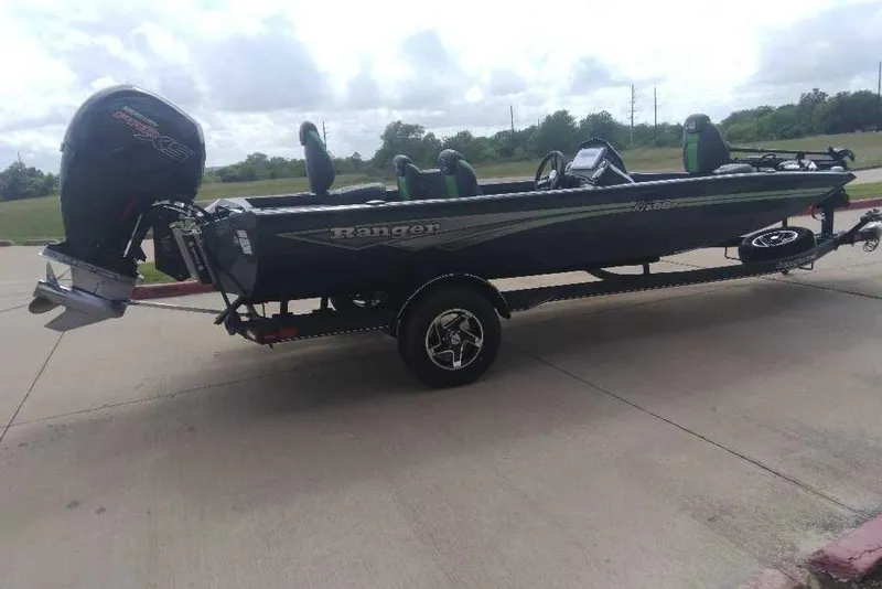 Slide: The Image of 2026 Ranger RT198P boat on trailer, parked outdoors under cloudy sky. - 82