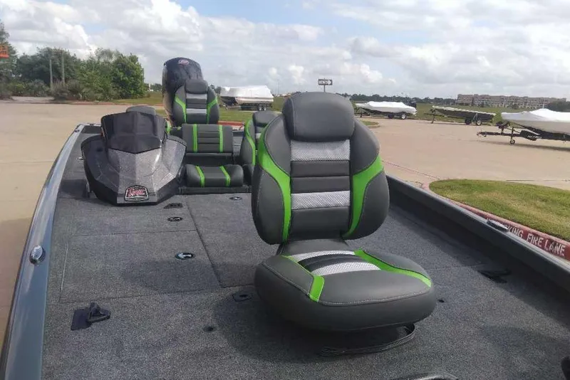 Slide: The Image of 2026 Ranger RT198P boat with green and gray seating, parked outdoors under a cloudy sky. - 85