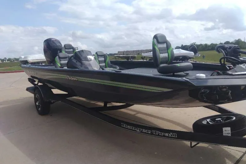 Slide: The Image of 2026 Ranger RT198P boat on trailer, sleek design, green accents, parked outdoors. - 86