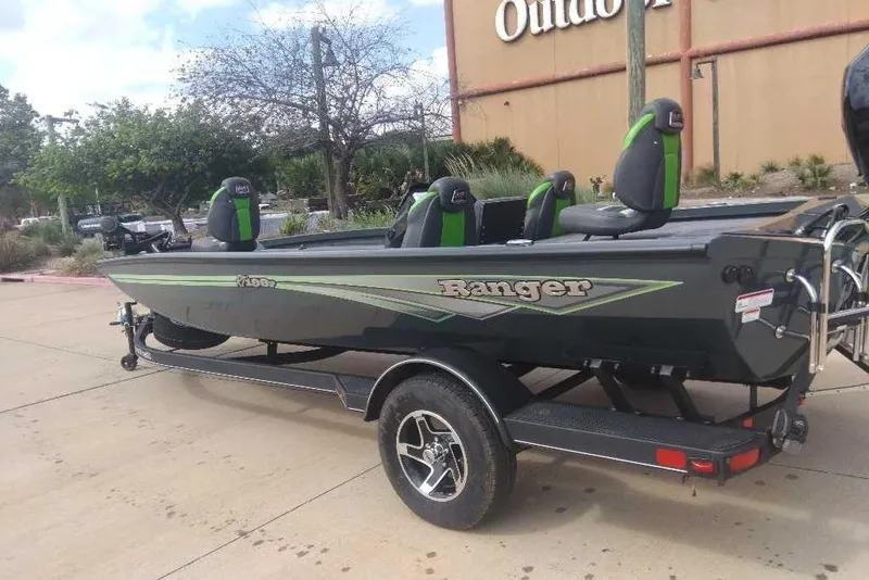 Slide: The Image of 2026 Ranger RT198P boat with green accents on a trailer, parked outdoors. - 88