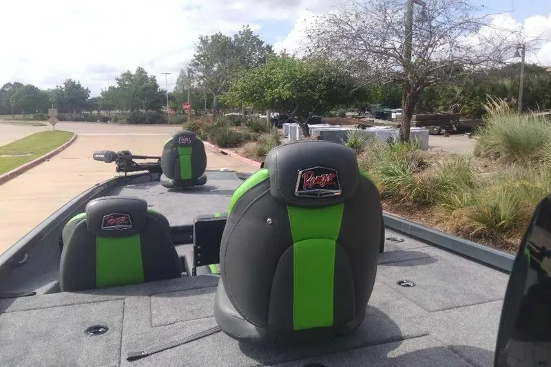 Slide: The Image of 2026 Ranger RT198P boat with green and black seats, parked outdoors. - 89