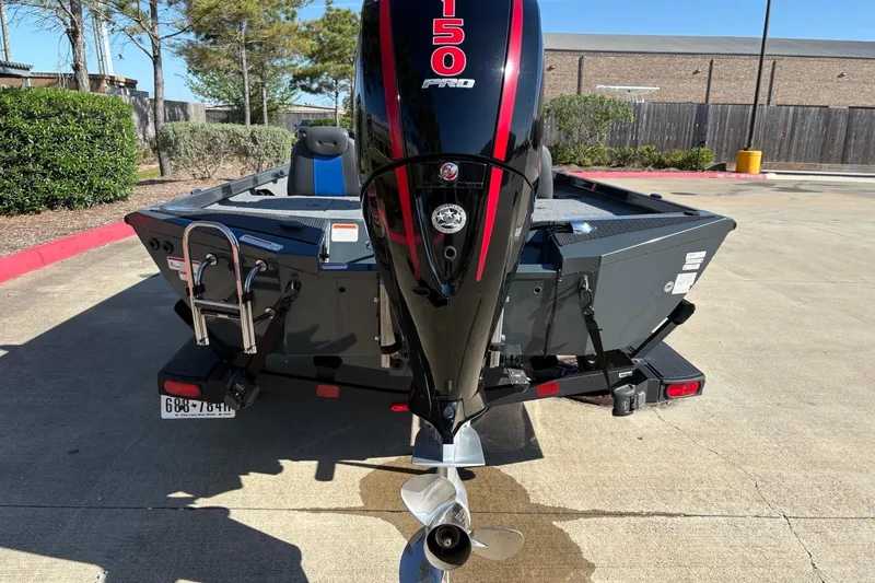 Slide: The Image of 2026 Ranger RT198P boat with powerful outboard motor, parked on concrete surface. - 16