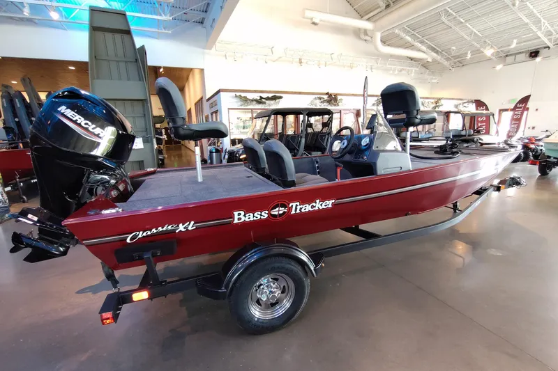 Slide: The Image of 2026 Tracker Bass Tracker Classic XL boat in showroom, featuring Mercury engine. - 68