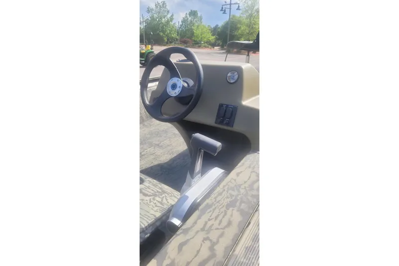 Slide: The Image of 2026 Tracker Grizzly 1754 SC boat interior with steering wheel and controls. - 2