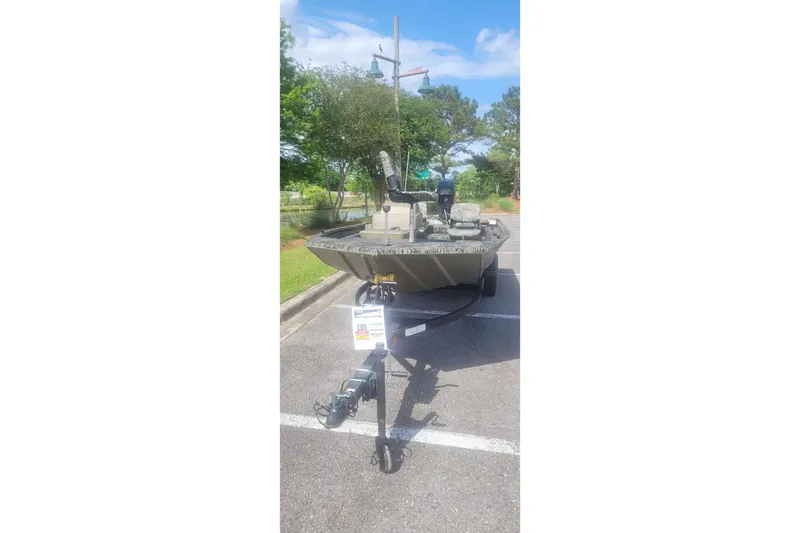 Slide: The Image of 2026 Tracker Grizzly 1754 SC boat parked outdoors on a sunny day. - 3