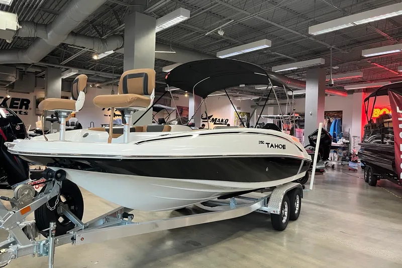 The Image of 2026 Tahoe 2150 boat displayed in a showroom, featuring sleek design and modern seating. - 0