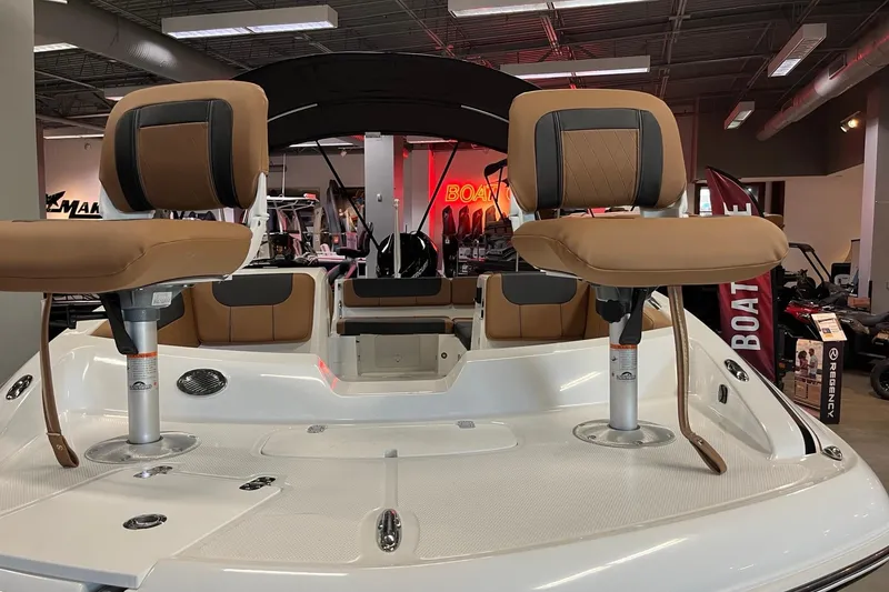 Slide: The Image of 2026 Tahoe 2150 boat interior with tan seats in a showroom setting. - 9