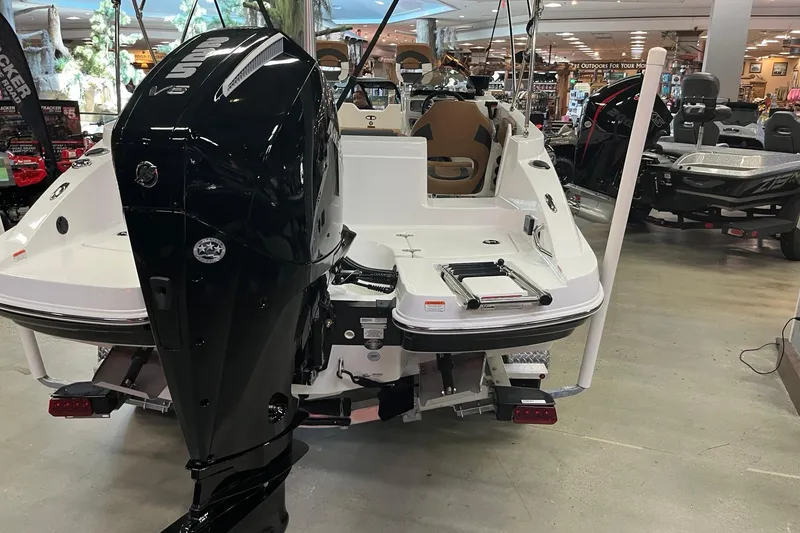 Slide: The Image of 2026 Tahoe 2150 boat with powerful outboard motor displayed indoors. - 4