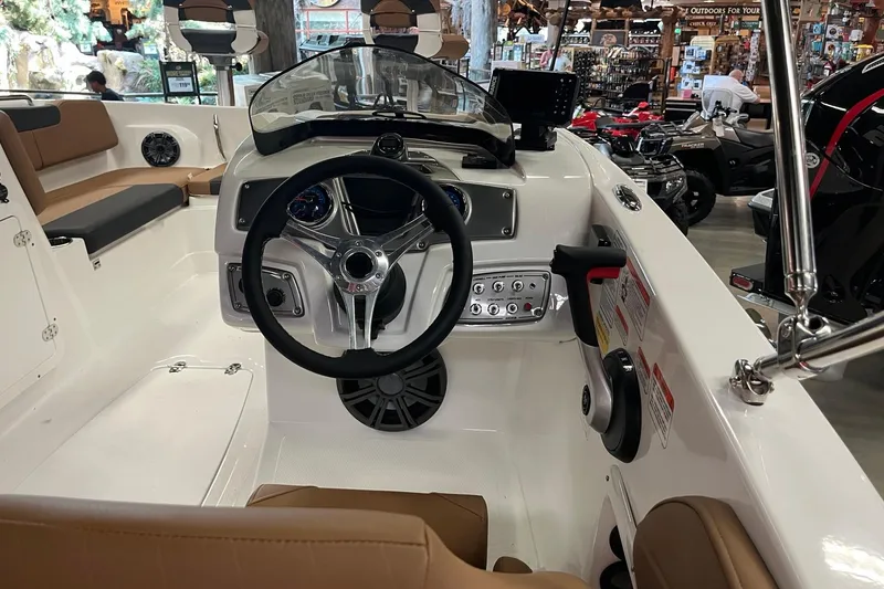 Slide: The Image of Interior view of a 2026 Tahoe 2150 boat, featuring a sleek steering wheel and modern dashboard. - 7