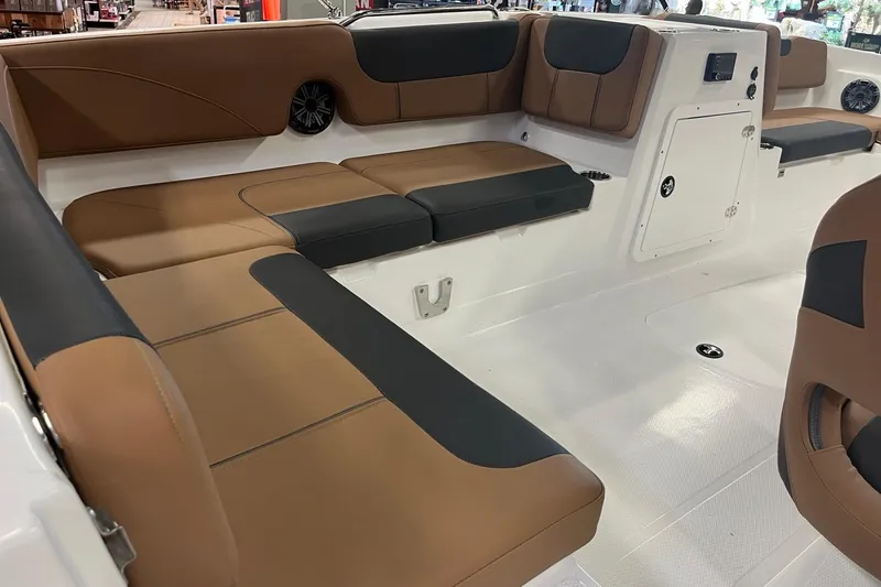 Slide: The Image of Interior of 2026 Tahoe 2150 boat with brown and black cushioned seating. - 8