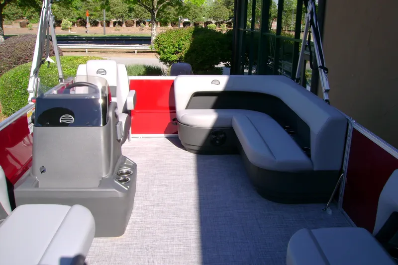 Slide: The Image of 2026 Sun Tracker Party Barge 16 DLX interior with gray seating and red accents. - 65