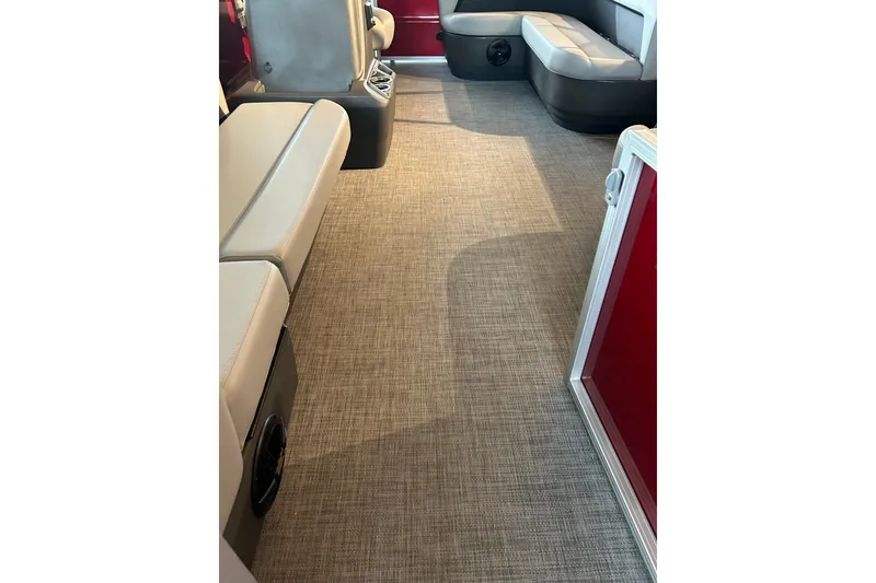 Slide: The Image of Interior of 2026 Sun Tracker Party Barge 16 DLX with beige seating and carpet flooring. - 3