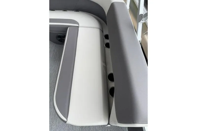 Slide: The Image of 2026 Sun Tracker Bass Buggy 18 DLX boat seating with cup holders, gray and white upholstery. - 90