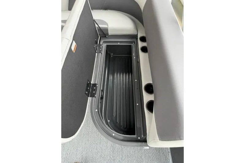 Slide: The Image of 2026 Sun Tracker Bass Buggy 18 DLX storage compartment with cup holders and seating. - 89