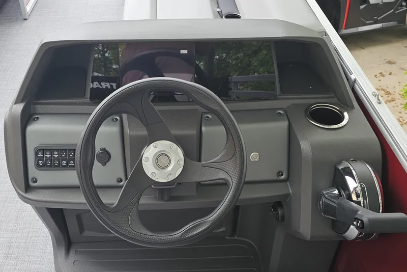 Slide: The Image of Steering console of 2026 Sun Tracker Party Barge 18 DLX with controls and cup holder. - 8