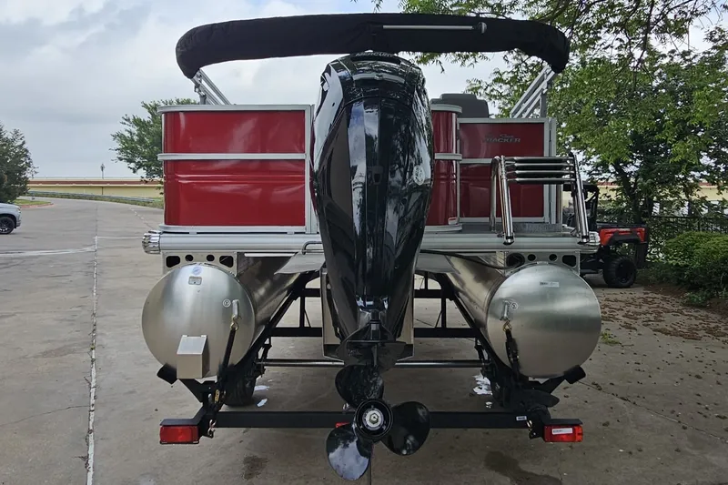 Slide: The Image of 2026 Sun Tracker Party Barge 18 DLX pontoon boat, rear view with motor and ladder. - 5
