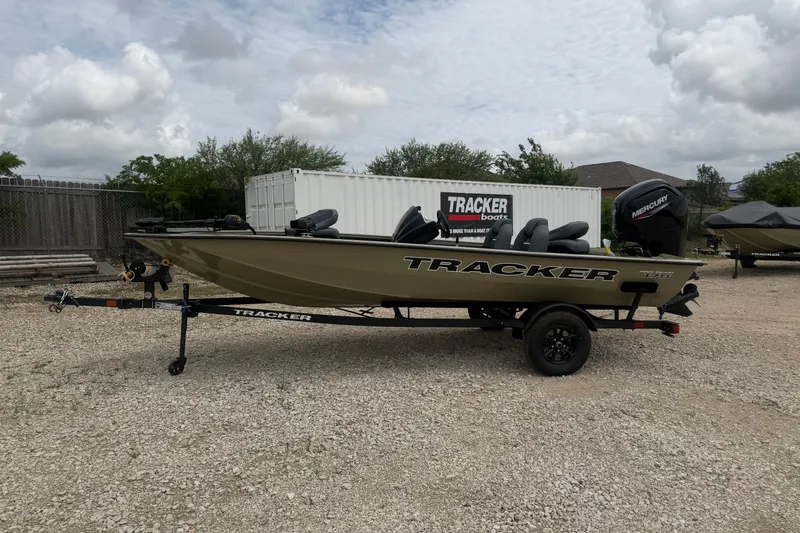 The Image of 2026 Tracker Pro Team 175 boat on trailer, parked outdoors under cloudy sky. - 0