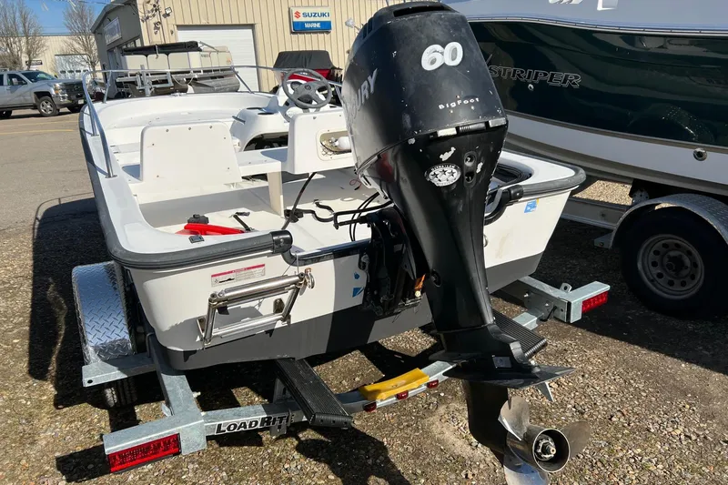 Slide: The Image of 2006 Boston Whaler 150 Sport boat with Mercury 60 outboard motor on trailer. - 11