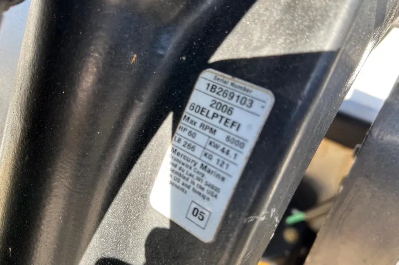 Slide: The Image of Label on a 2006 Boston Whaler 150 Sport boat engine, showing specifications. - 12