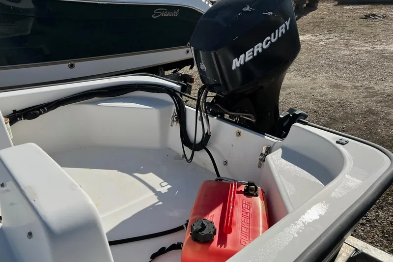 Slide: The Image of 2006 Boston Whaler 150 Sport boat with Mercury outboard motor and red fuel tank. - 4