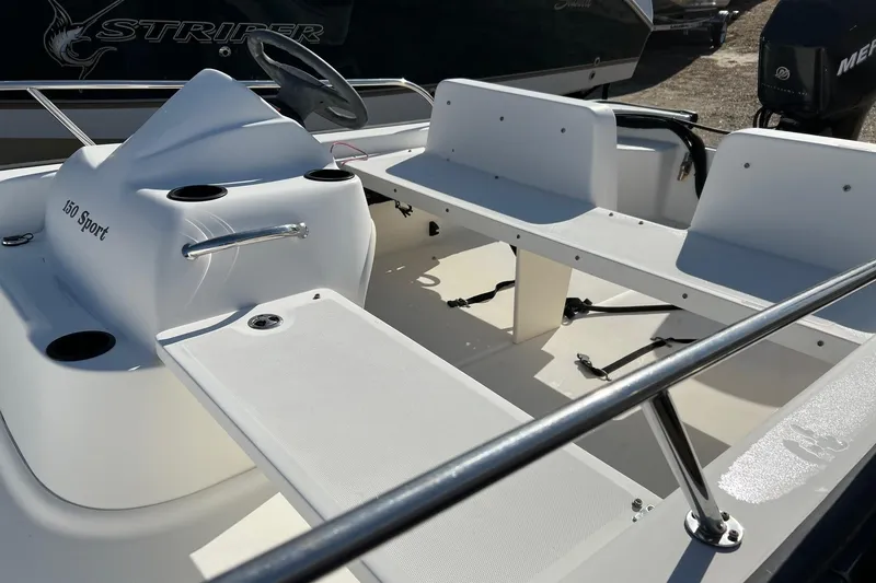Slide: The Image of 2006 Boston Whaler 150 Sport boat interior with seating and steering console. - 6