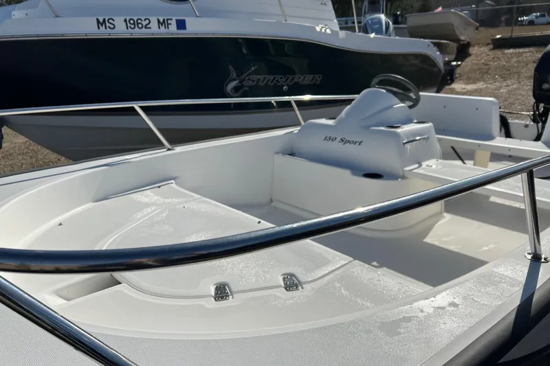 Slide: The Image of 2006 Boston Whaler 150 Sport boat interior with steering console and seating. - 7